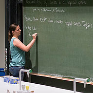 A speaker of the 2015 conference giving a talk at the blackboard