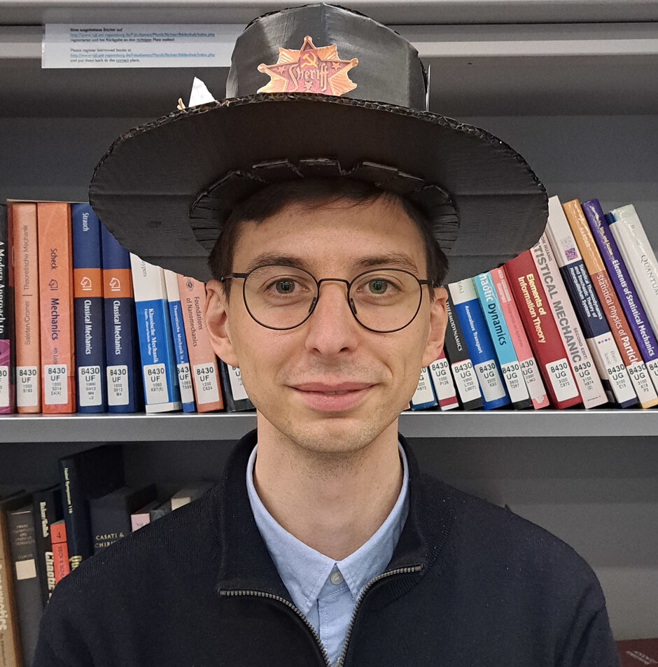 Yaroslav Zhumagulov with his Ph.D. hat