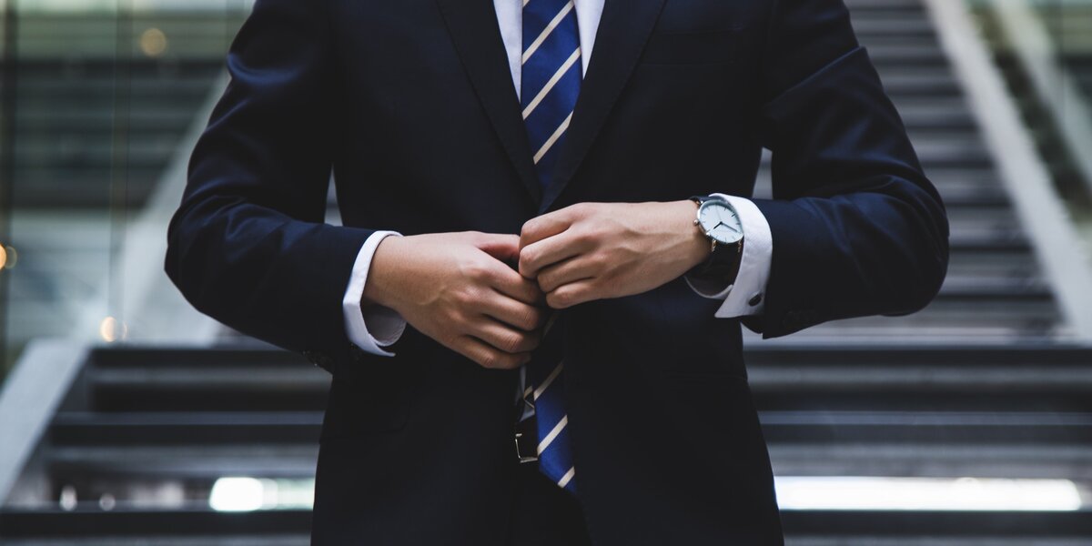 Man in a dark blue suit.