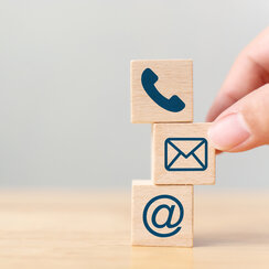 Hand putting wooden block cube symbol telephone, email, address. Website page contact us or e-mail marketing concept