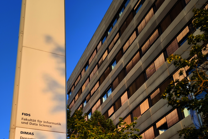 Stele in front of the entrance to the FIDS building (opens enlarged image)