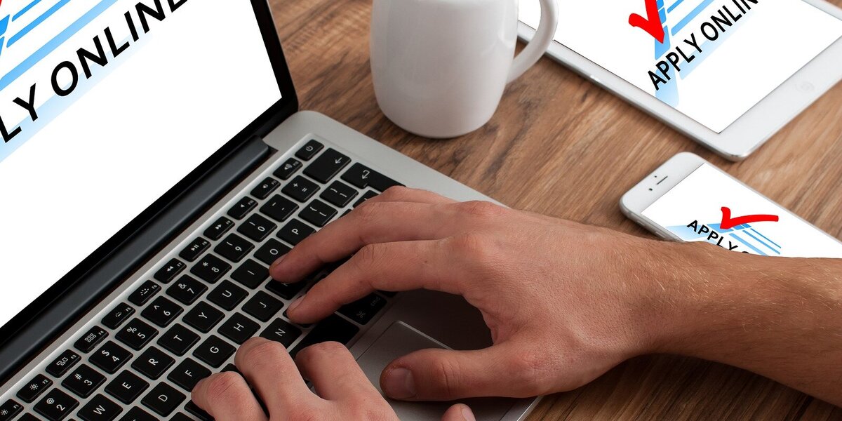 Hands typing on a laptop.