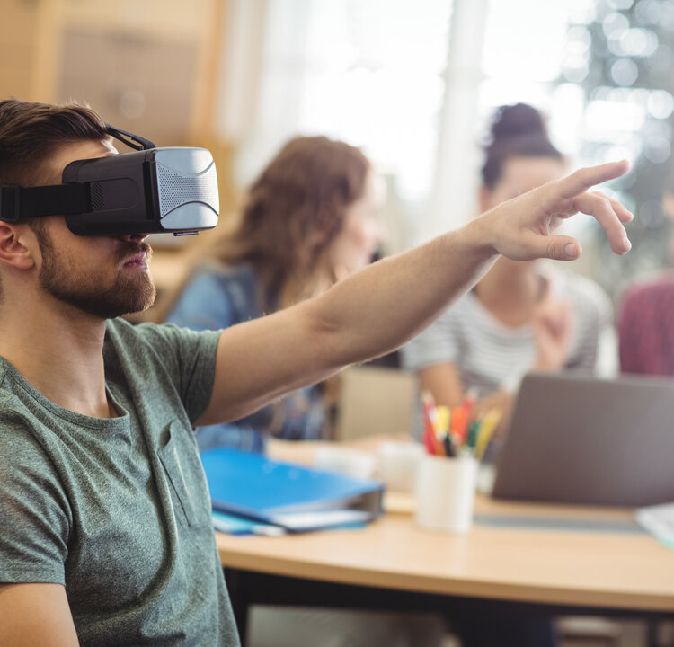 Male business executive using virtual reality headset