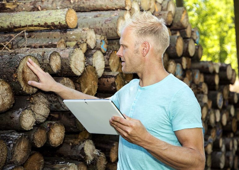 Man in the woods with Tablet PC